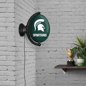 Michigan State Spartans: Original Oval Rotating Lighted Wall Sign - The Fan-Brand