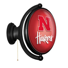 Load image into Gallery viewer, Nebraska Cornhuskers: Original Oval Rotating Lighted Wall Sign - The Fan-Brand