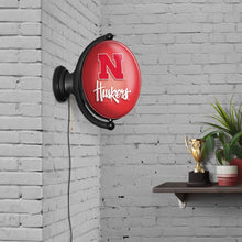 Load image into Gallery viewer, Nebraska Cornhuskers: Original Oval Rotating Lighted Wall Sign - The Fan-Brand