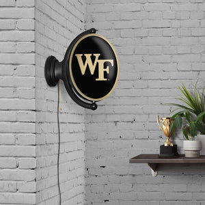 Wake Forest Demon Deacons: Original Oval Rotating Lighted Wall Sign - The Fan-Brand